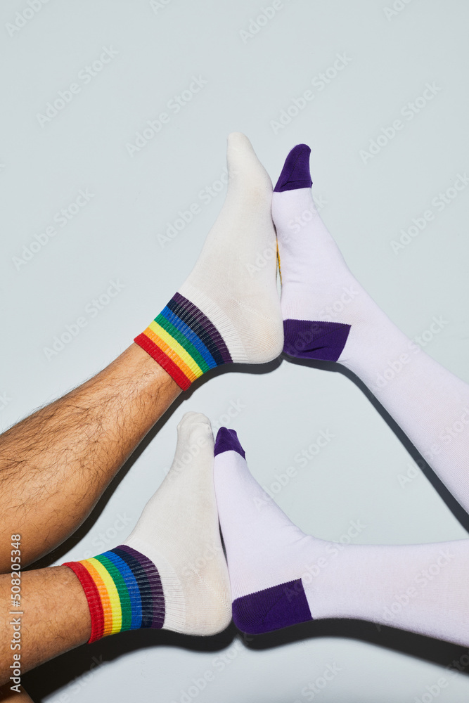Minimal shot of playful young couple wearing socks feet up, copy space Minimal shot of playful young couple wearing socks feet up, copy space