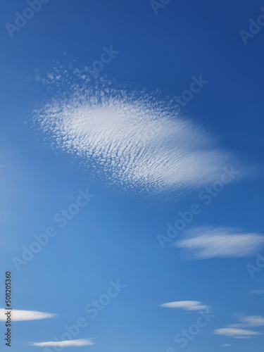 Abstract cirrus clouds on the blue sky background. Beautiful cloudscape scene photo