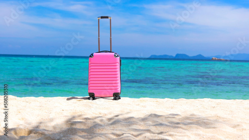 Fototapeta Naklejka Na Ścianę i Meble -  The Banner of travel  a holiday vacation in Summer tropical concept with Pink luggage on the white sand Beach background