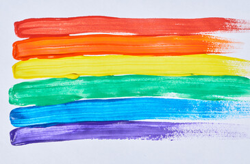 Background image of vibrant rainbow flag in paint with smudges, copy space