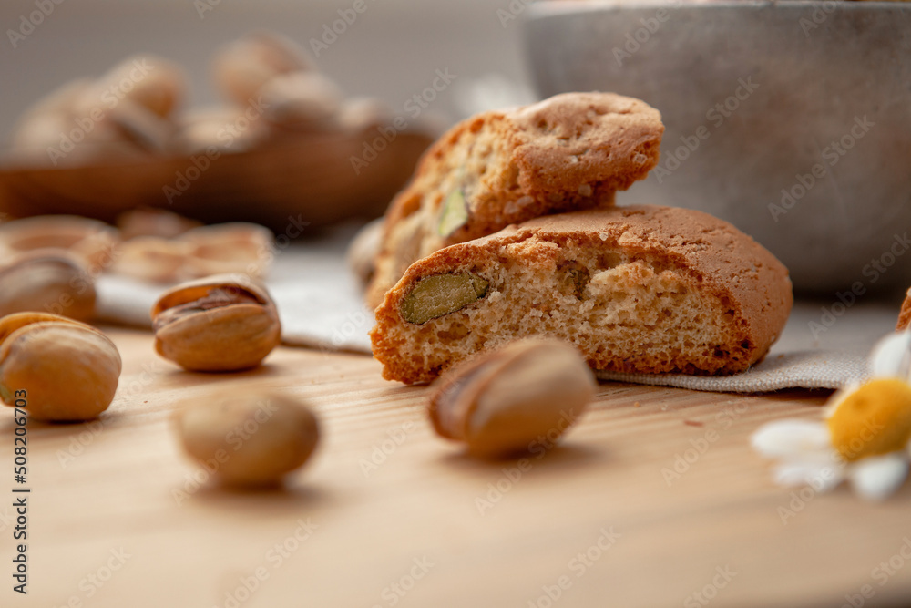 Pistachios and some cantucci on a wooden table Pistachios and some cantucci on a wooden table