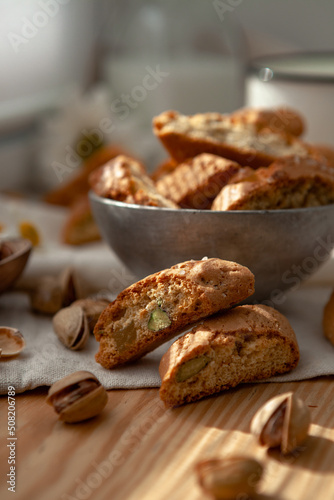 Two pieces of Italian cantucci with pistachio pieces. Traditional dessert. selective focus