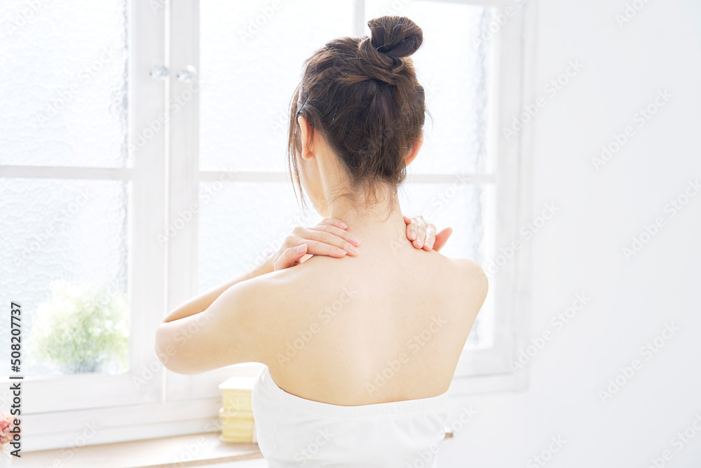 自宅でで肩のケアをする女性 自宅でで肩のケアをする女性