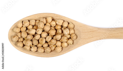 Raw chickpeas in wooden spoon isolated on white, top view 