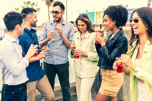 Photography Group of happy young friends with drinks gathered for party in park - Happy peop