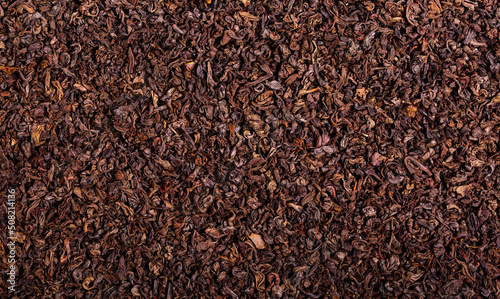 Dried black tea leaves close up as a background. Flower tea, useful herbs for brewing a drink.