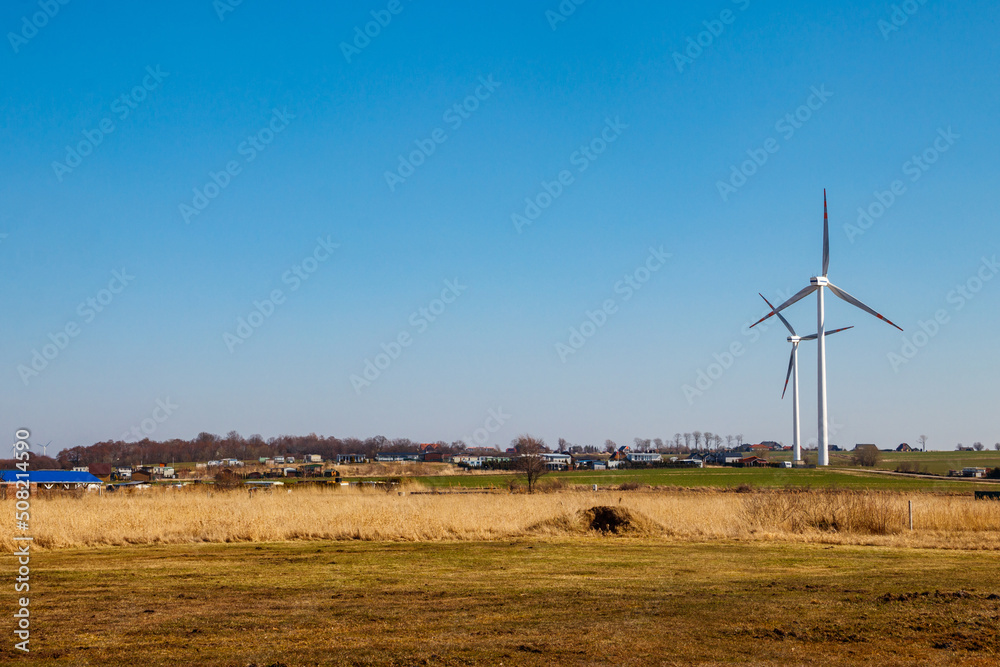 Wind turbines in a village. Renewable energy Wind turbines in a village. Renewable energy