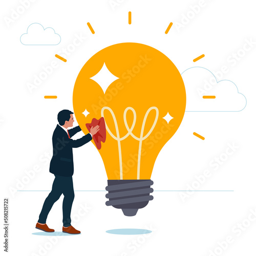 Smart entrepreneur cleans and polishes light bulb for best quality idea. Polishing idea or finalize to be perfect and best quality result, attention to details, craftsmanship concept.