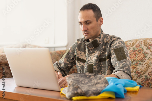 Message for world peace. military with laptop and flag of ukraine