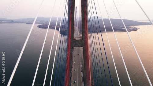 View from above. Russian bridge in Vladivostok across the Eastern Bosphorus. The camera flies between the guys over the roadway.