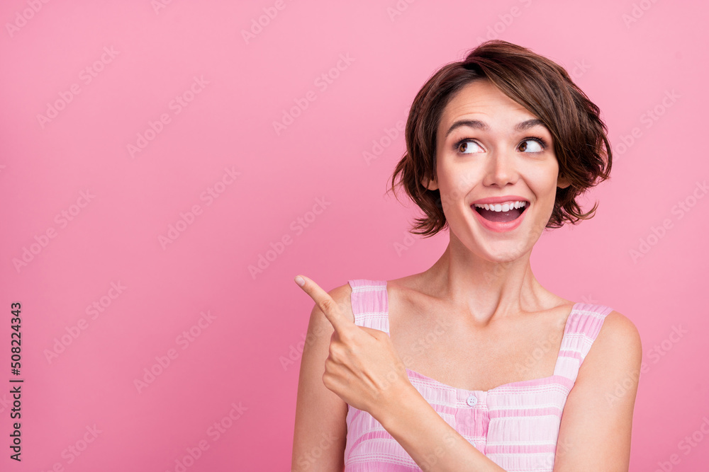 Photo of young cheerful lady wondered look indicate finger empty space promotion advert advise isolated over pink color background Photo of young cheerful lady wondered look indicate finger empty space promotion advert advise isolated over pink color background