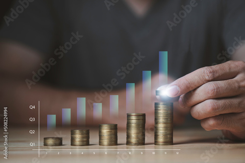Businessman hand holding coin on stack coins, Save money and investment growth concept.