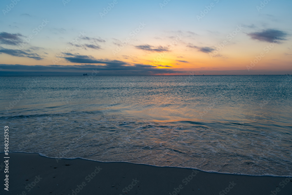 beautiful afterglow with sea water on the summer beach