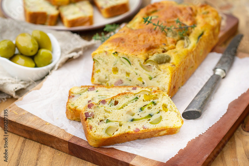 French savoury cake with olives, zucchini, ham and cheese