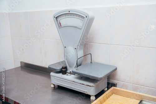 old scales are on the table against the background of tiles