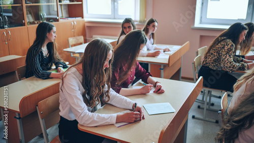 Pupils of the 11th grade in the class at the desks during the lesson. Russian school.
