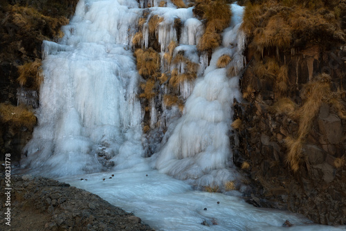 Mountain waterfall frozen at the Sani Pass, Drakensberg Mountains in South Africa.