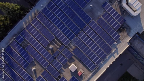 Solar panels installation and mounting on the top roof of the city building. Alternative power plant with solar cell farm for charging and storing electric power.