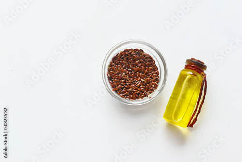top view of flax seeds and oil on white background 