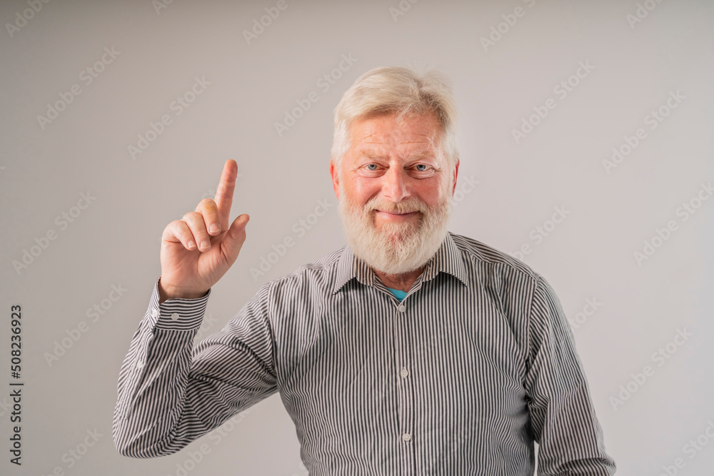 an elderly retired man raised his finger to attract attention to a new good idea an elderly retired man raised his finger to attract attention to a new good idea