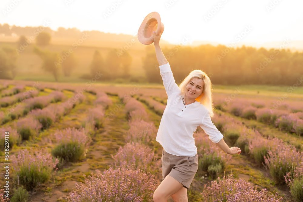 Fototapeta premium A Woman Walking in Lavender Field
