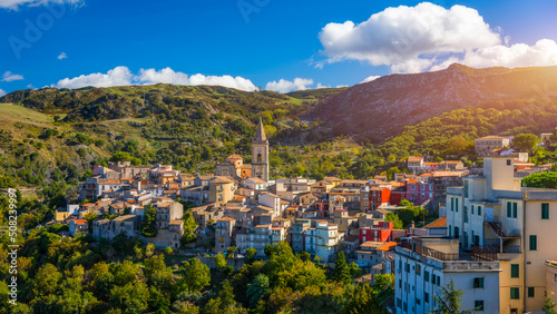 Fototapeta Naklejka Na Ścianę i Meble -  Picturesque street with the Duomo in the background in Novara di Sicilia, Sicily, Italy. Amazing cityscape of Novara di Sicilia town. Mountain village Novara di Sicilia, Sicily, Italy.