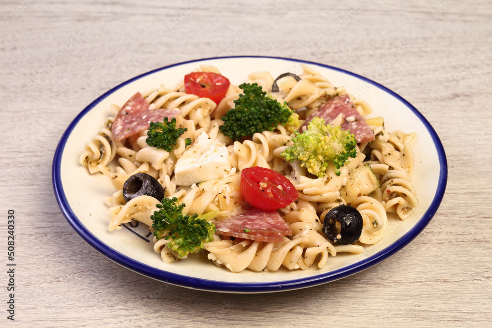 Pasta salad with tomatoes, ham, black olives, broccoli and cheese Pasta salad with tomatoes, ham, black olives, broccoli and cheese