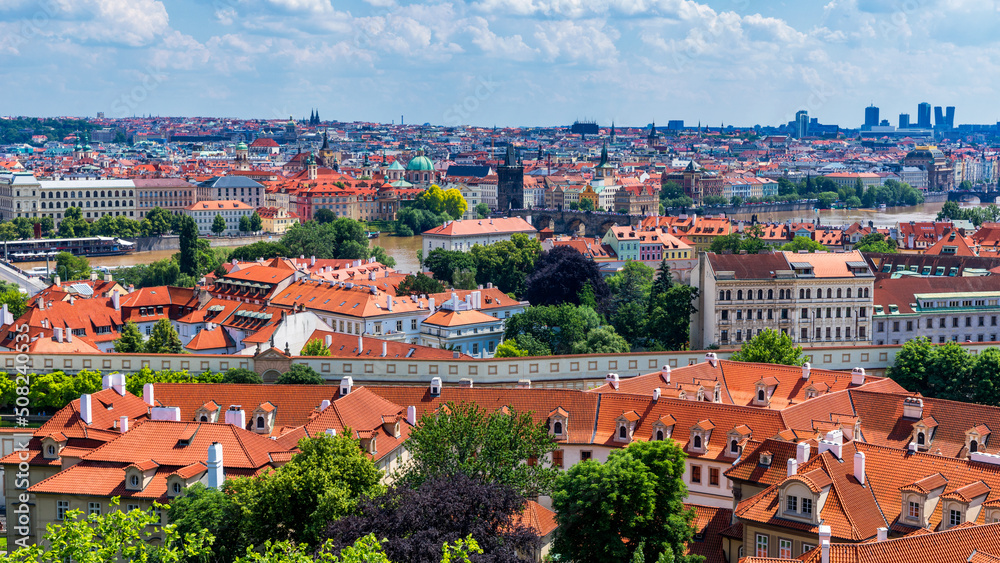 Obraz premium Old town of Prague. Czech Republic over river Vltava with Charles Bridge on skyline. Prague panorama landscape view with red roofs. Prague view from Petrin Hill, Prague, Czechia.