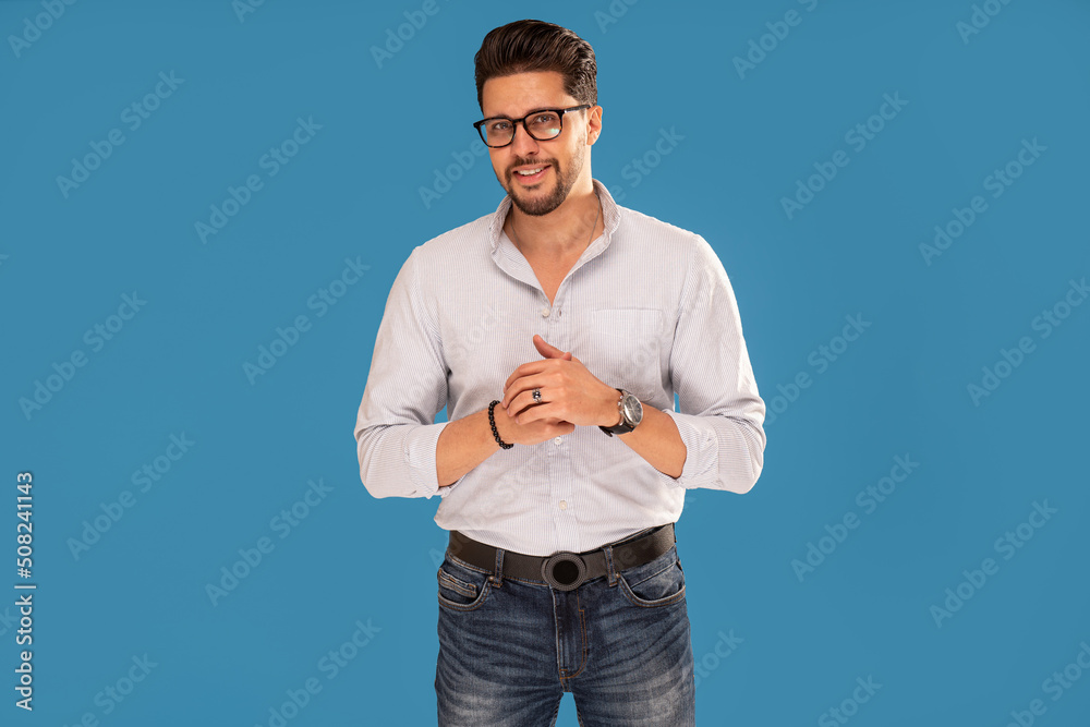 Handsome young confident man in fashionable clothes looking at the camera and smiling. Handsome young confident man in fashionable clothes looking at the camera and smiling.