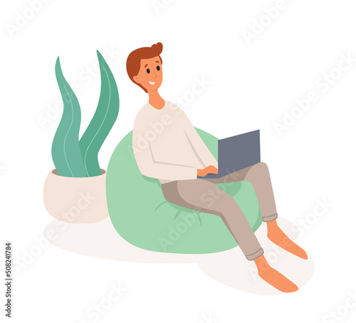 A young man sits in a bean bag. Freelancer works making use of laptop from home. Flat vector illustration. Remote work, office at home, programming, freelance. Study at home in quarantine. 