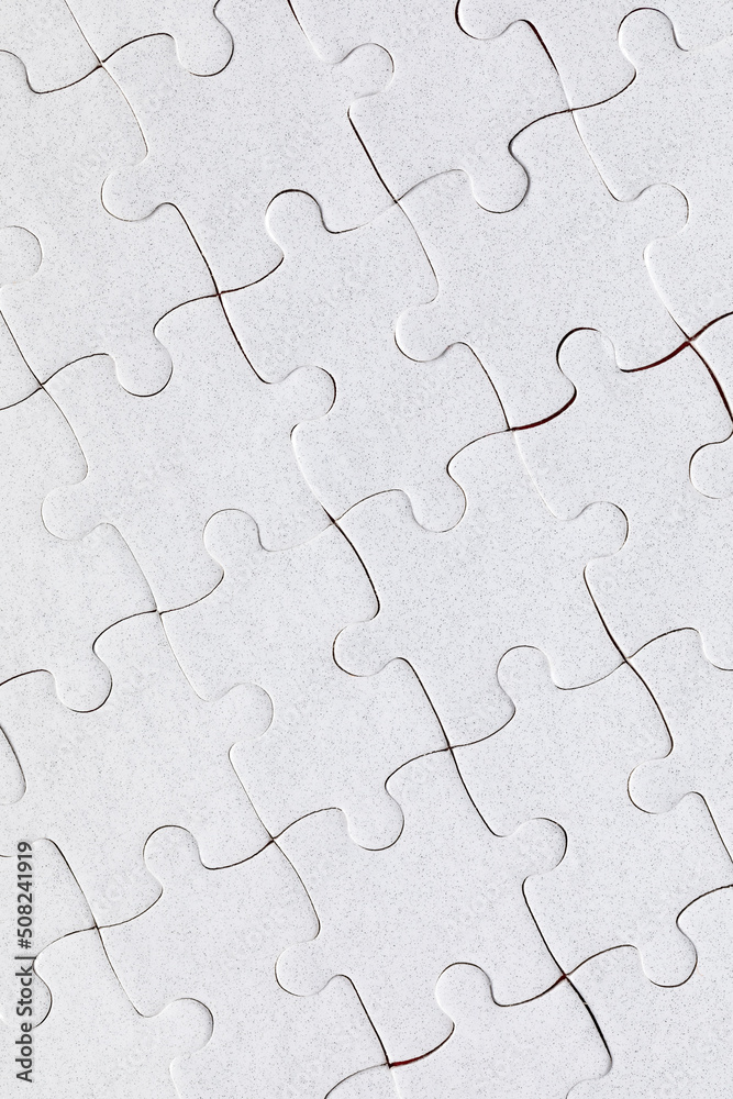 White jigsaw puzzle. White puzzle pieces on color background. Unfinished white jigsaw puzzle pieces on color background. White jigsaw puzzle. White puzzle pieces on color background. Unfinished white jigsaw puzzle pieces on color background.