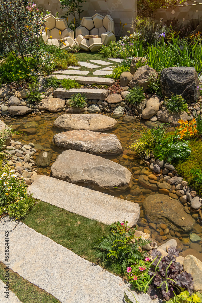 Beautiful pond and Creek with rocks and flowers in the flower gaden park Beautiful pond and Creek with rocks and flowers in the flower gaden park