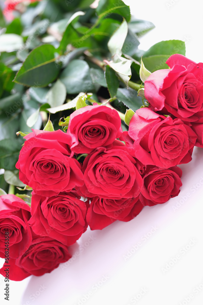 Beautiful bouquet of red roses lies on white background Beautiful bouquet of red roses lies on white background