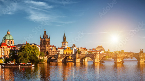 View of the Vltava River and Charle bridge with autumn red foliage, Prague, Czech Republic