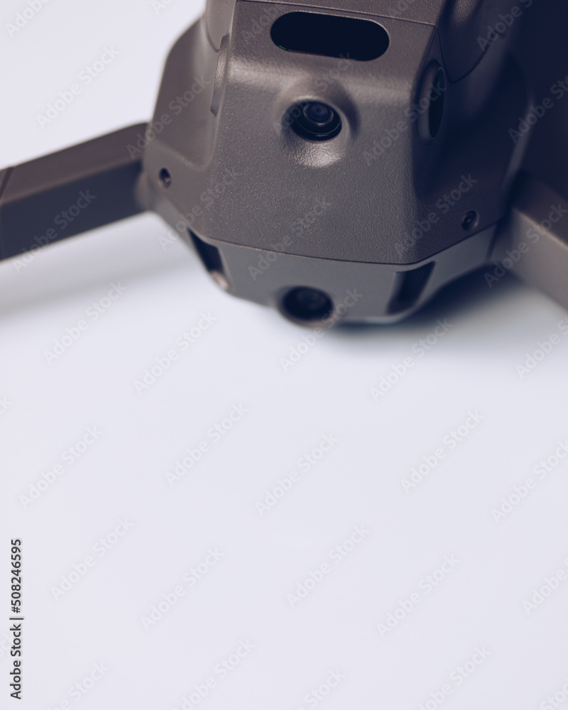 New modern drone on display on white background. Drone quadcopter with digital camera. New modern drone on display on white background. Drone quadcopter with digital camera.