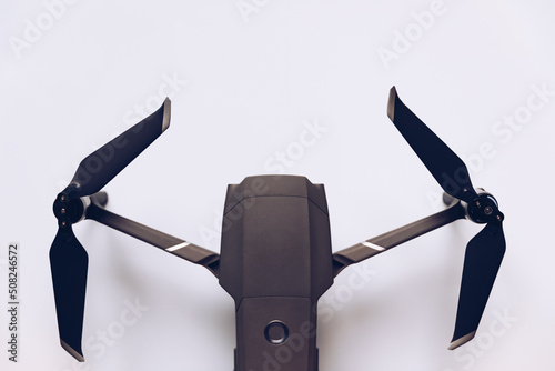 New modern drone on display on white background. Drone quadcopter with digital camera. photo