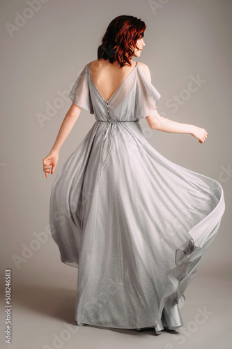 Beautiful young woman in dust blue dress Fototapet
