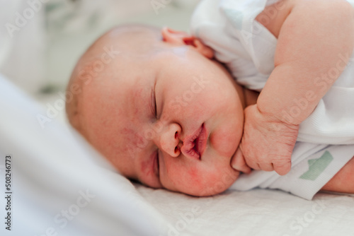 Portrait of a cute sleeping Caucasian newborn baby. Soft focus