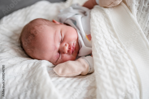 Portrait of a cute sleeping Caucasian newborn baby. Soft focus