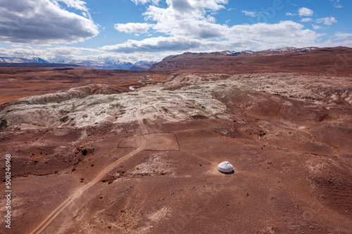 Lonely yurt of nomads around winding river and mountains Altai Republic Russia, white sand in Moon valley, aerial top view sunny day photo