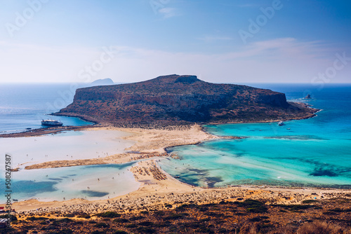 Fantastic panorama of Balos Lagoon and Gramvousa island on Crete, Greece. Cap tigani in the center. Balos beach on Crete island, Greece. Tourists relax and bath in crystal clear water of Balos beach. photo