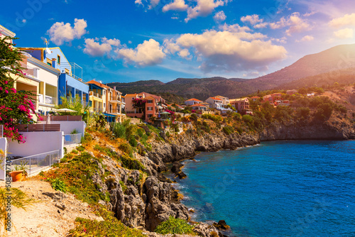 Turquoise colored bay in Mediterranean sea with beautiful colorful houses in Assos village in Kefalonia, Greece. Town of Assos with colorful houses on the mediterranean sea, Greece.