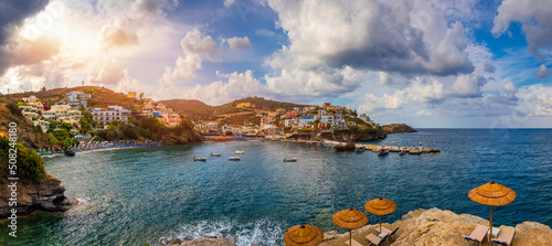 Panorama of Harbour with vessels, boats, beach and lighthouse in Bali at sunrise, Rethymno, Crete, Greece. Famous summer resort in Bali village, near Rethimno, Crete, Greece. photo