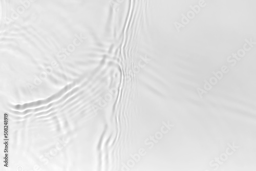 Waves on transparent water surface, gray abstract background.