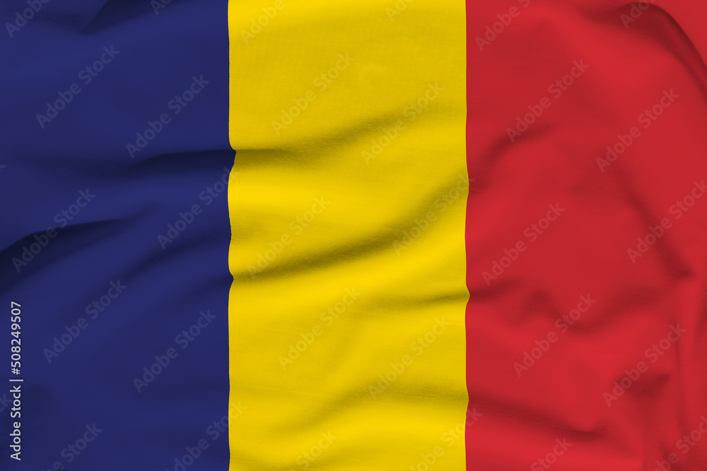Chad national flag, folds and hard shadows on the canvas Chad national flag, folds and hard shadows on the canvas
