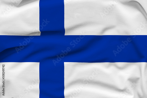 Finland national flag, folds and hard shadows on the canvas