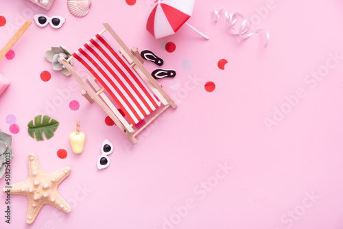 Accessories for beach holidays - deck chairs, umbrellas, ice cream top view. Beach party concept with copy space