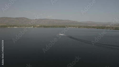 Aerial view of water bike moving along water surface at Bannoe lake, Bashkortostan photo