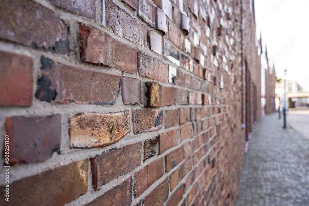 Brick wall of an ancient building on the street of a cozy provincial town. Brick wall of an ancient building on the street of a cozy provincial town.
