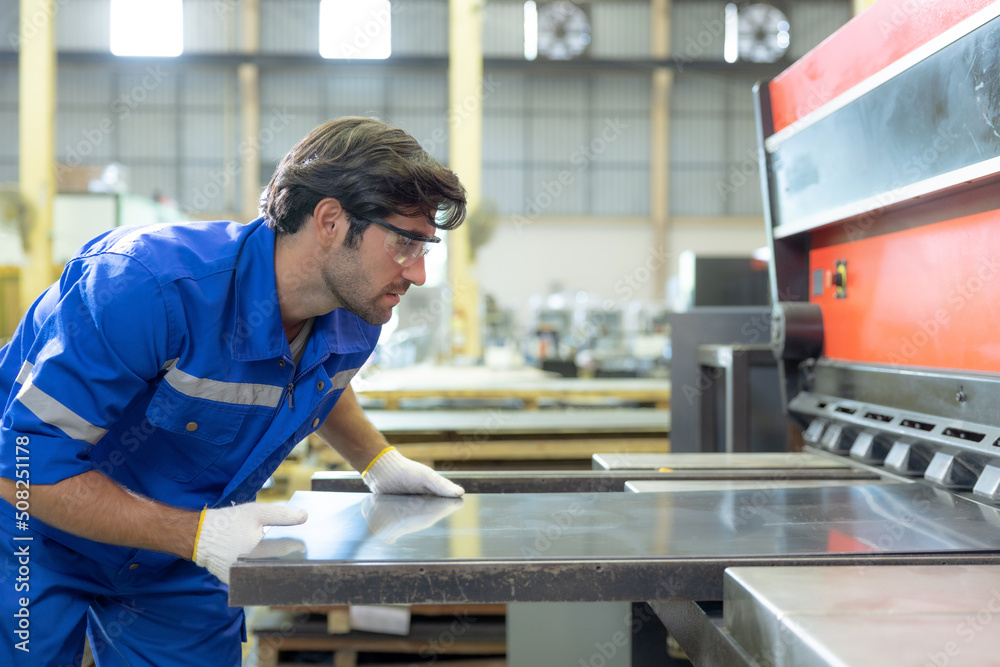 Workers cut sheet metal with modern cutting machines, Metallurgical industry factory. Workers cut sheet metal with modern cutting machines, Metallurgical industry factory.